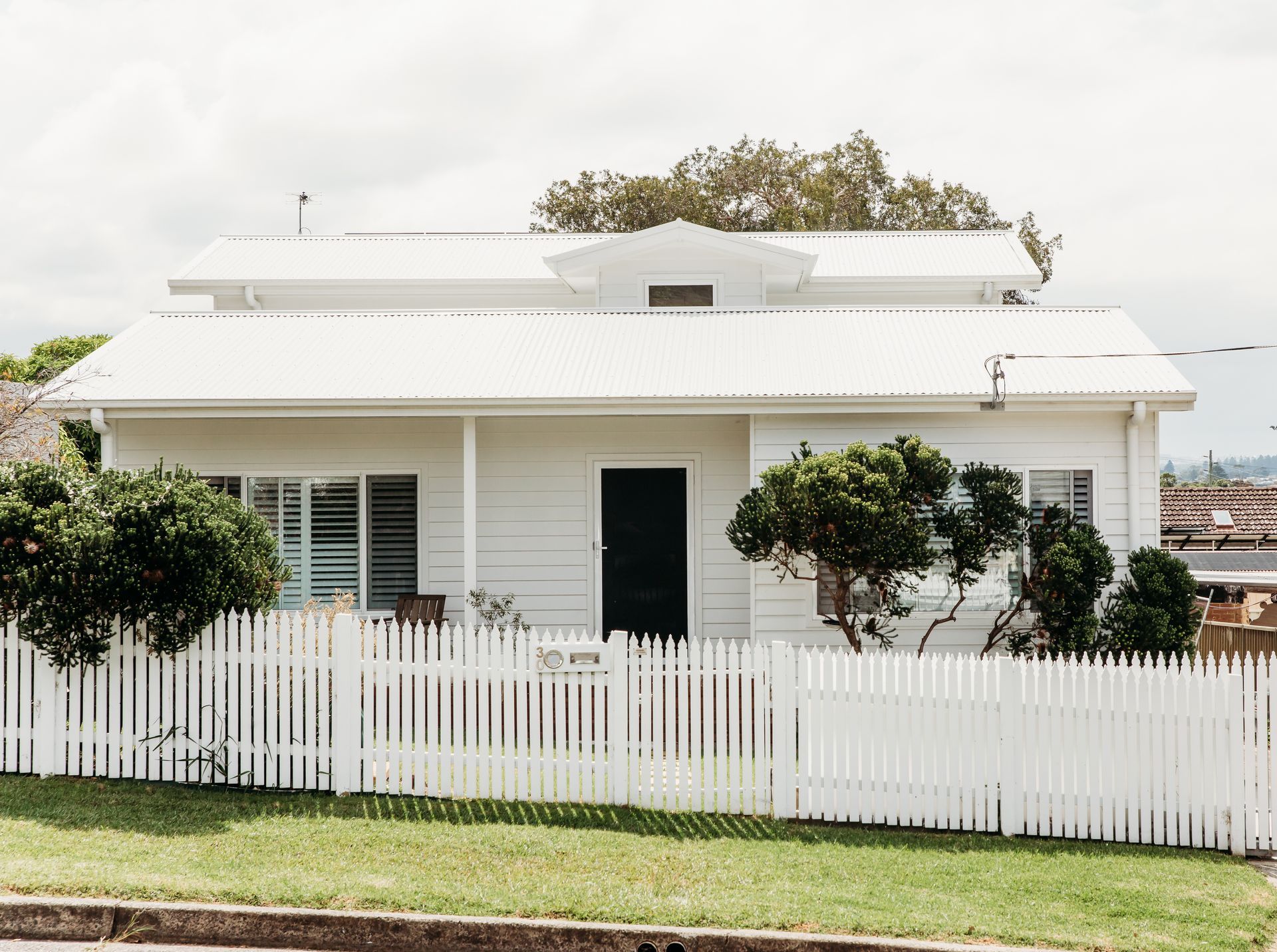 White house with a White Picket Fence— B Smart Building & Design In Shellharbour, NSW