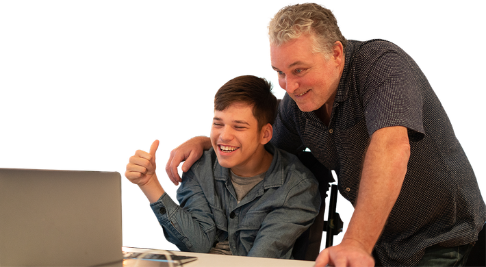 father and son happily staring at laptop