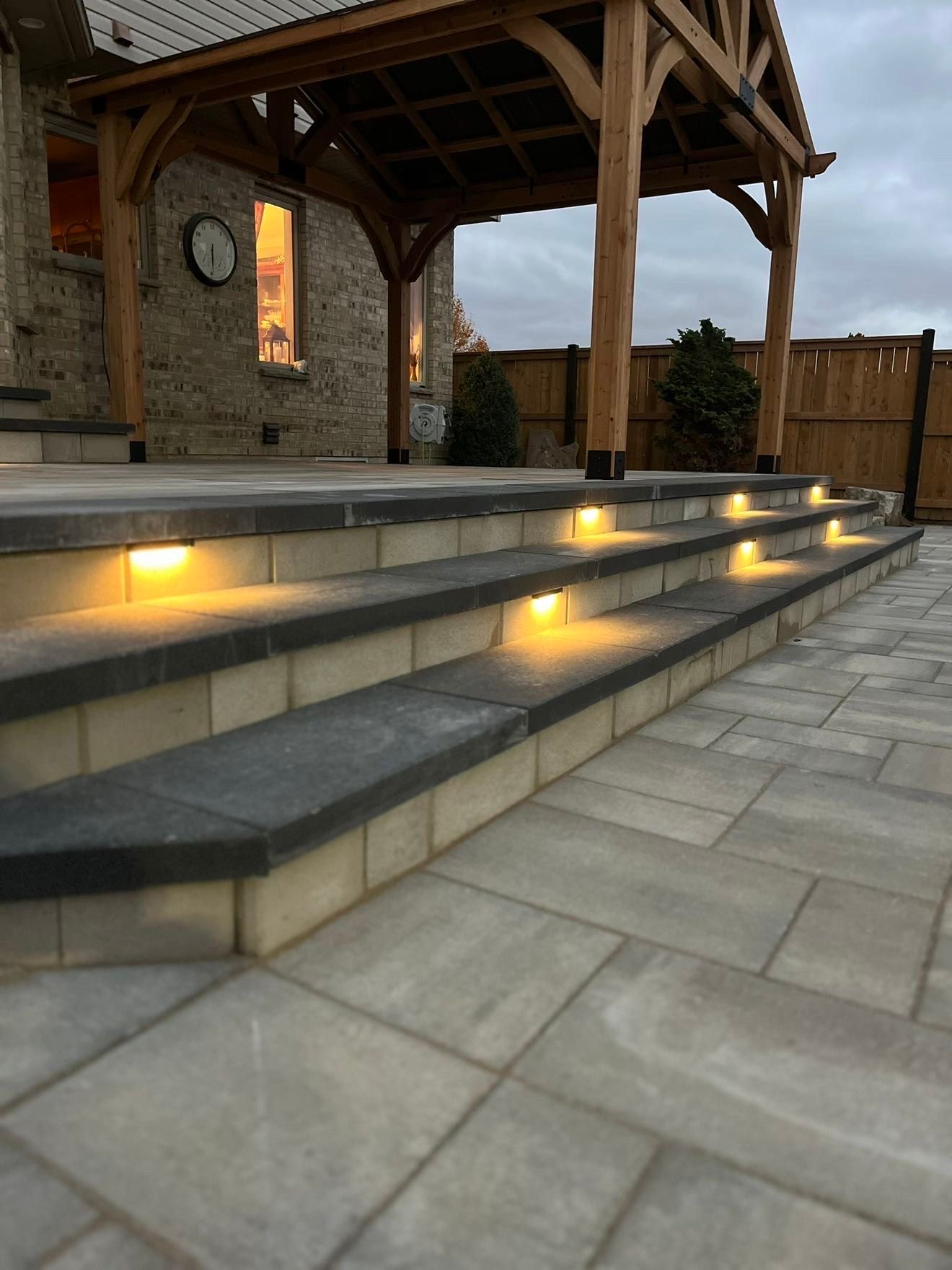 A set of stairs leading up to a house with lights on them