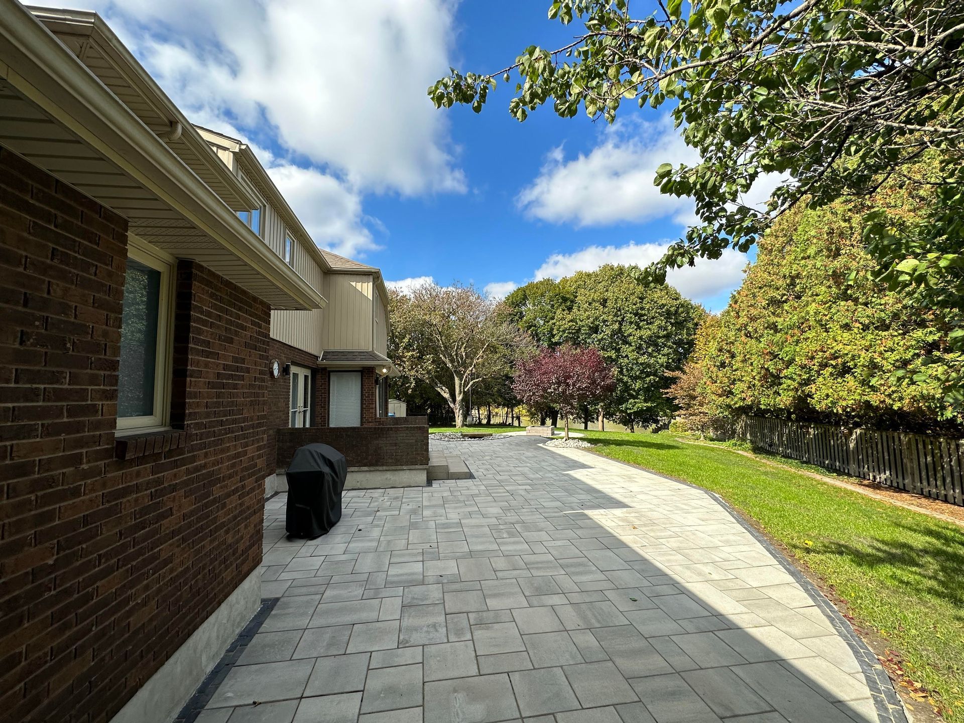 A brick house with a brick walkway leading to it