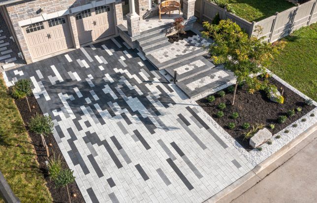 An aerial view of a driveway in front of a house.