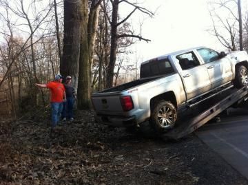 Pickup Truck in Woods Being Towed