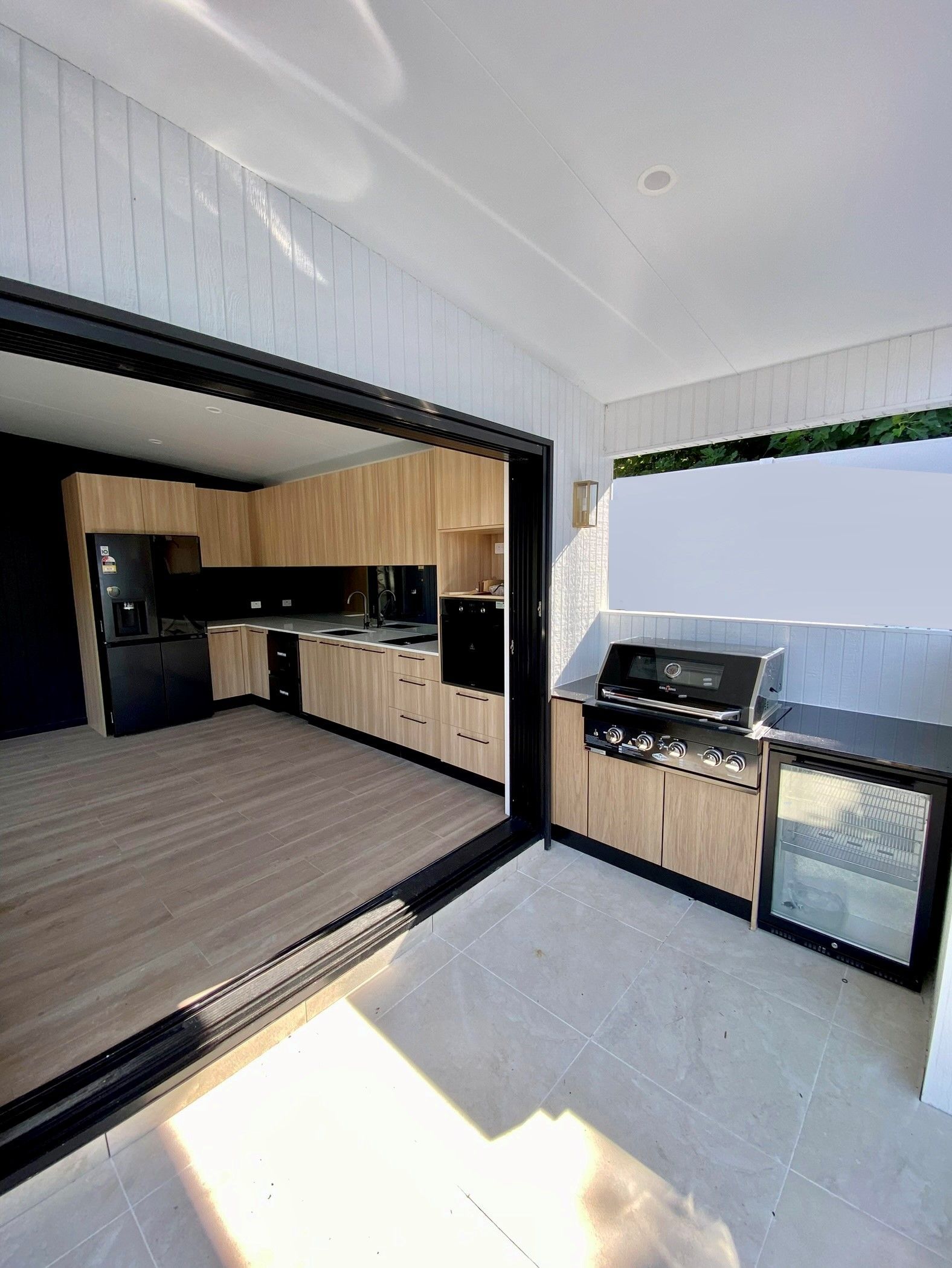 A brick house is being remodelled with a porch and a ladder  — Designer Building Pty Ltd In Charmhaven, NSW