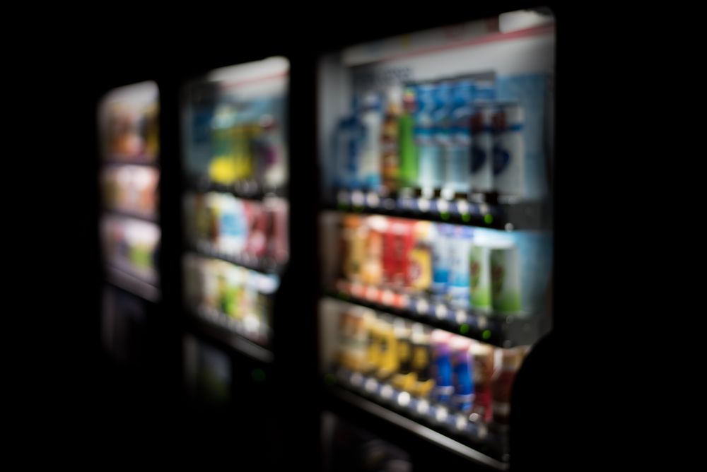 A Blurred Image of a Vending Machine Filled With Drinks — Central Coast Storage Solutions in Toormina, NSW