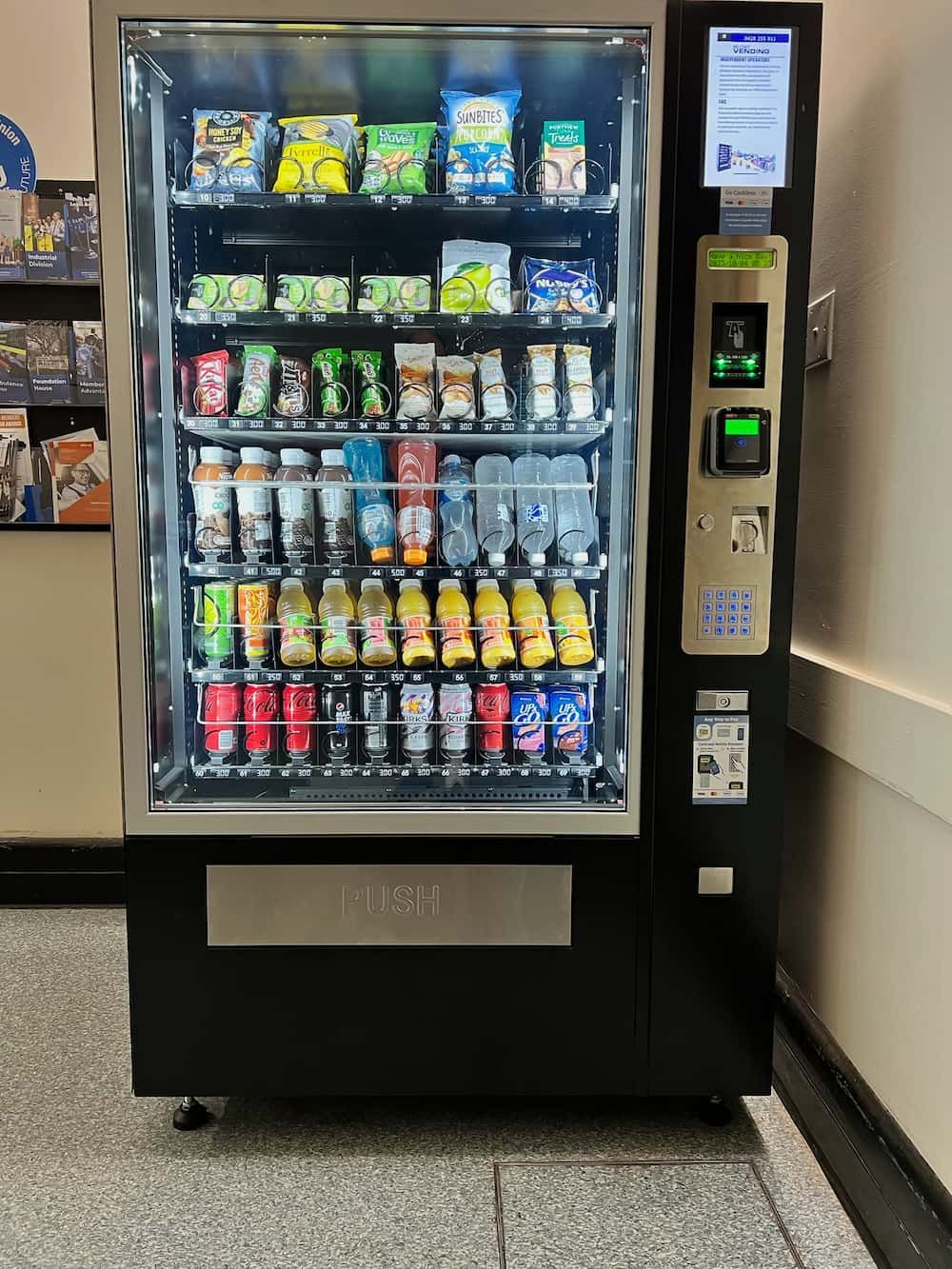 A Vending Machine Filled With Drinks and Snacks in a Hallway — Central Coast Storage Solutions in Toormina, NSW