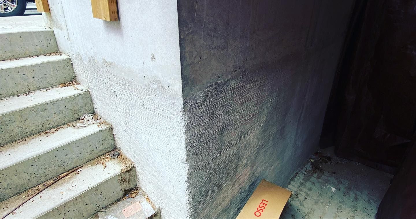 A skateboard is sitting on the ground next to a set of stairs.