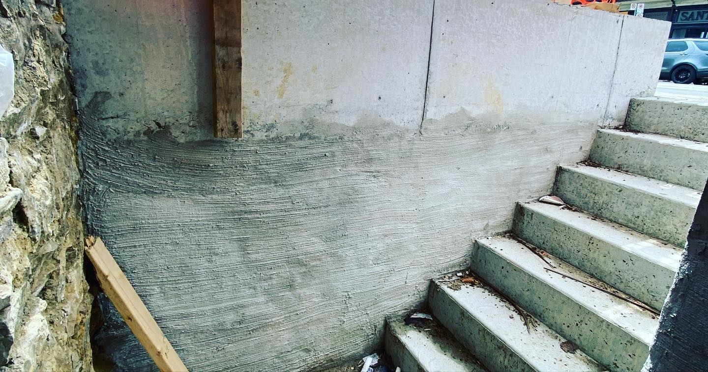 A set of concrete stairs leading up to a building under construction.