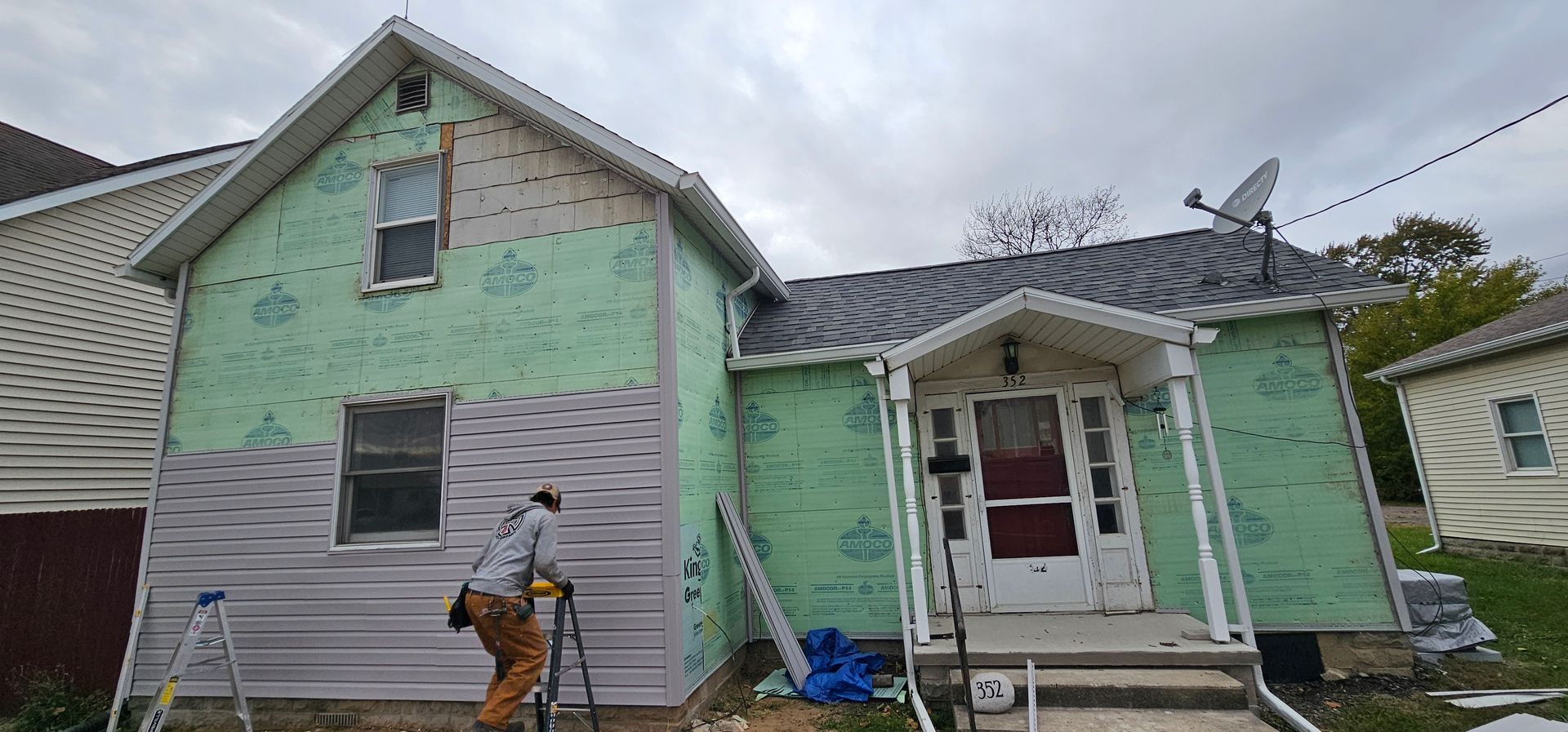 White horizontal wood siding with a large diagonal shadow across it