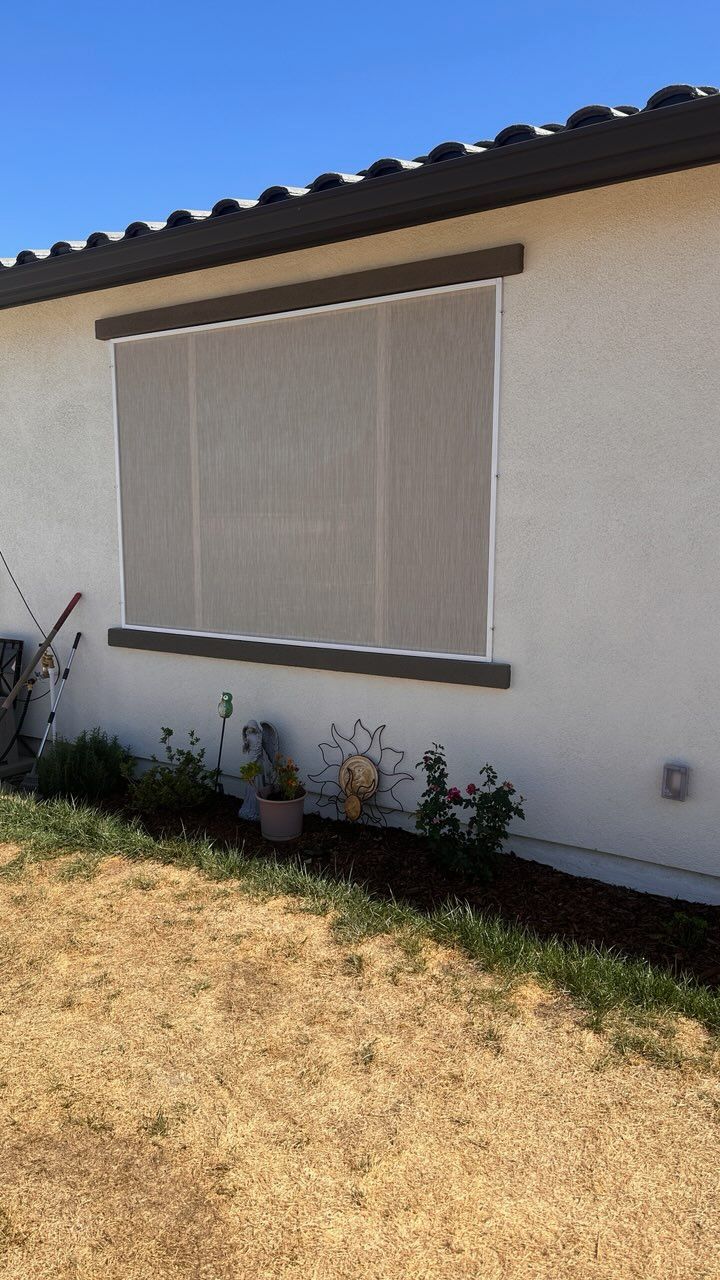 A white house with a large window on the side of it.