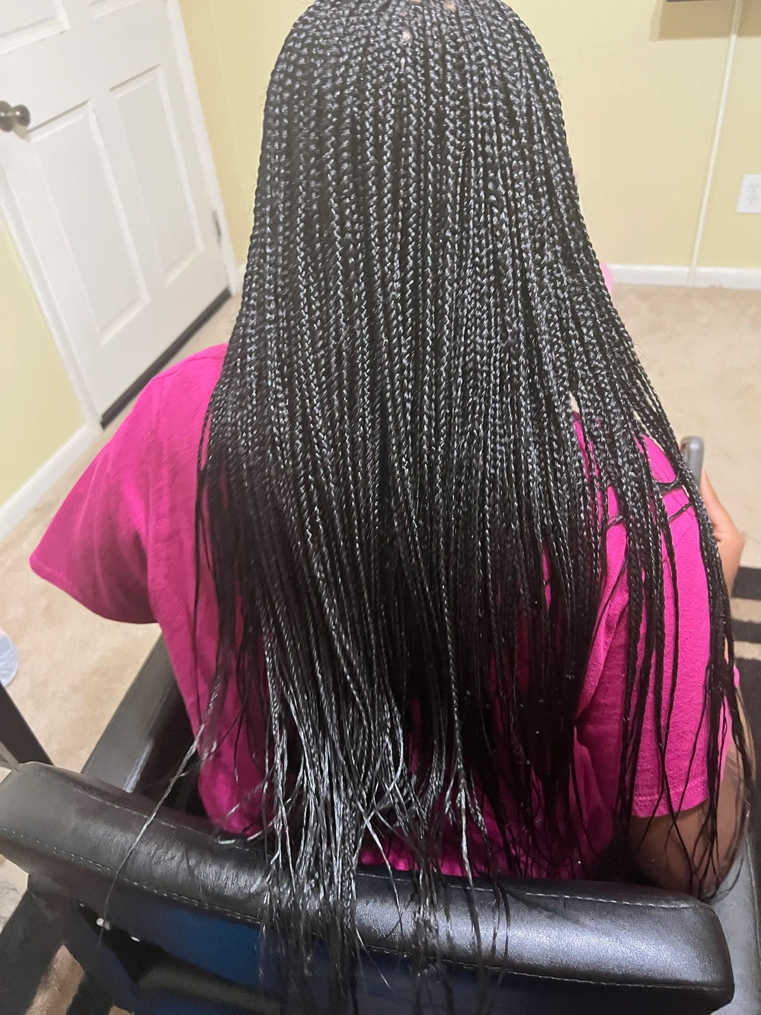 A Woman Is Sitting In A Chair With Braids In Her Hair | Fayetteville, NC | Fatouisa African Braiding