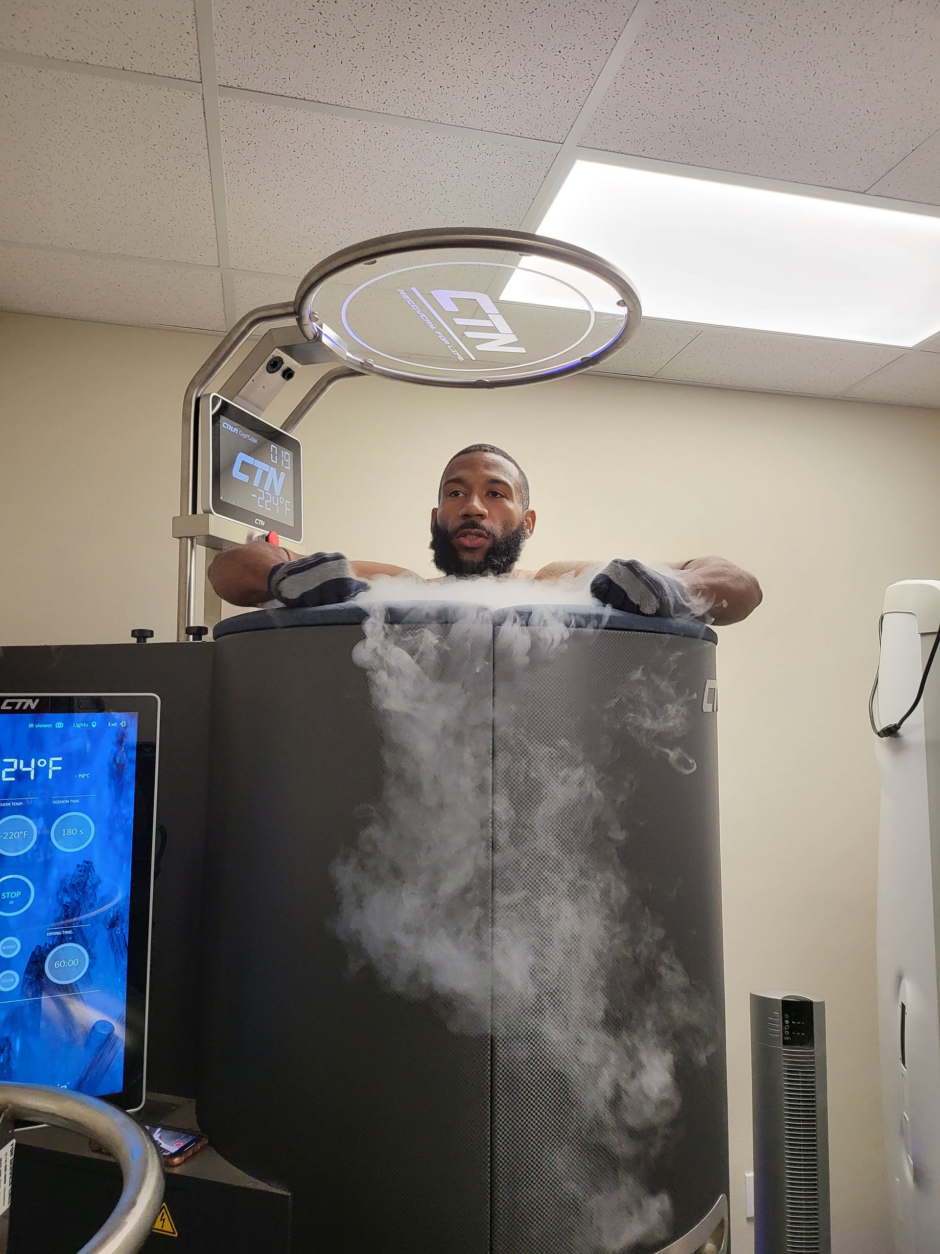 Adult using Whole Body Cryotherapy Chamber at Campus Motion Cryo Revovery
