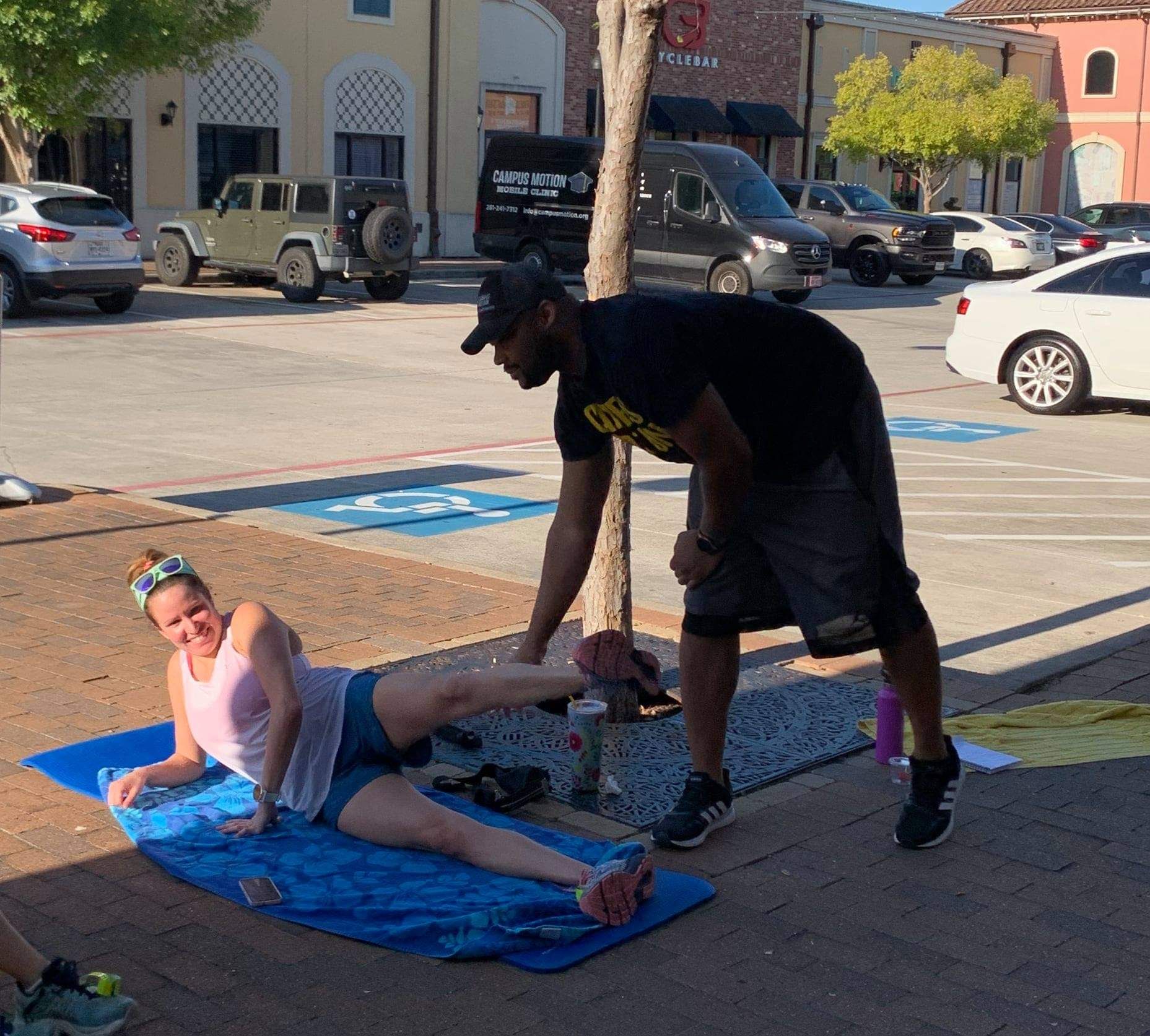 A physical therapist assisting a lady with physical therapy, focusing on Pain Reduction by alleviating muscle tension and addressing chronic pain conditions or post-injury discomfort.