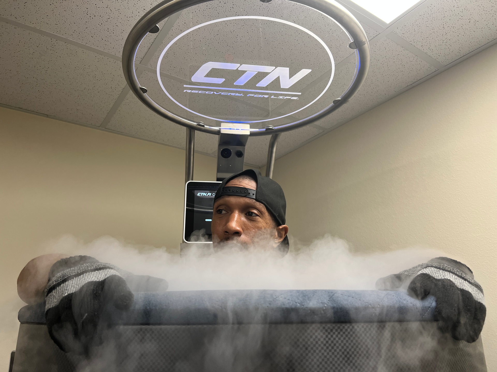 A man submerged in a cryotherapy chamber as part of Muscle Recovery therapy, which aids athletes in faster recovery by reducing muscle soreness and inflammation after intense workouts.