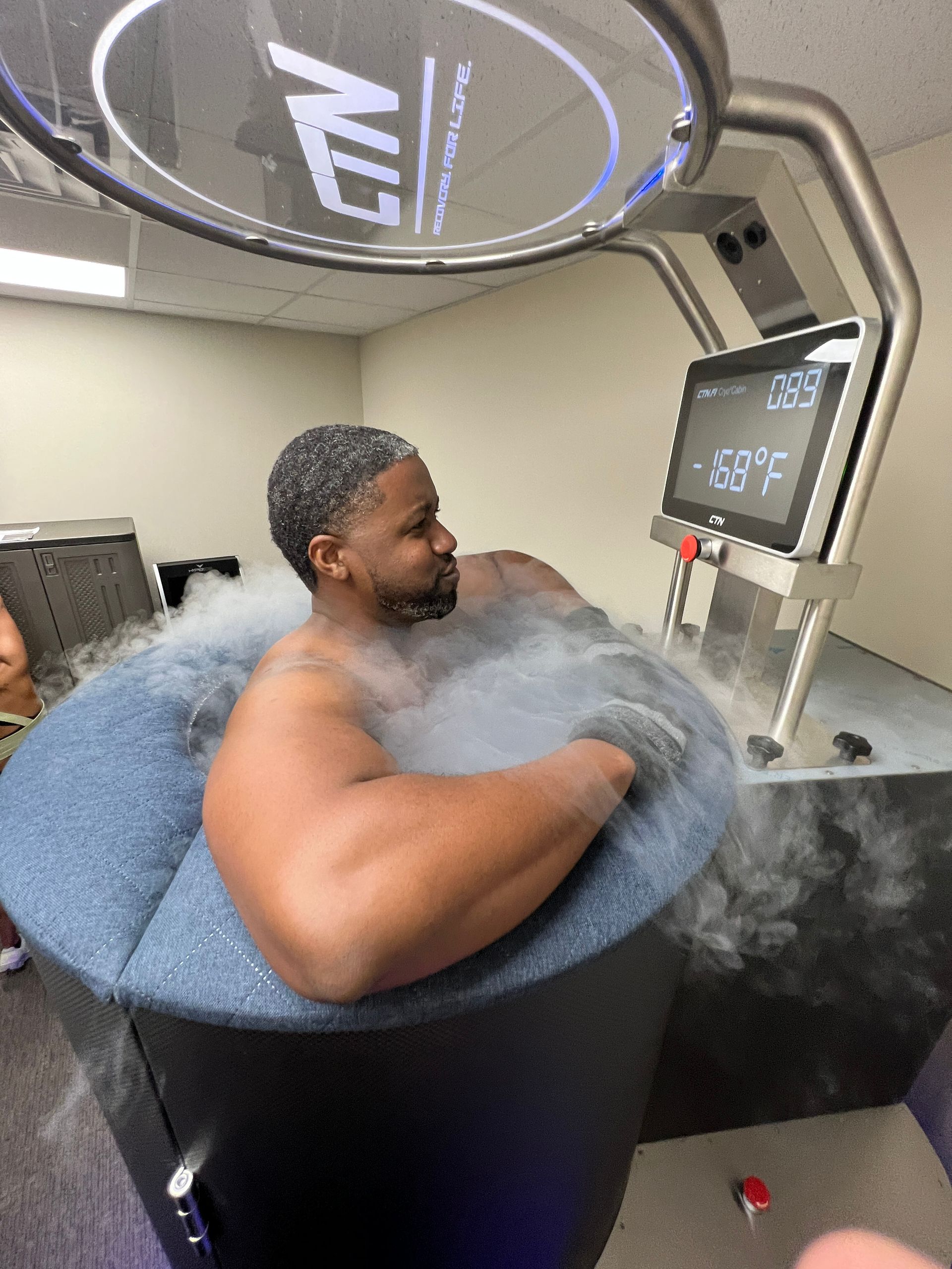 A man submerged in a cryotherapy machine, experiencing Pain Relief through cryotherapy's ability to reduce pain and inflammation, which can be beneficial for chronic pain, injuries, and post-surgery recovery.