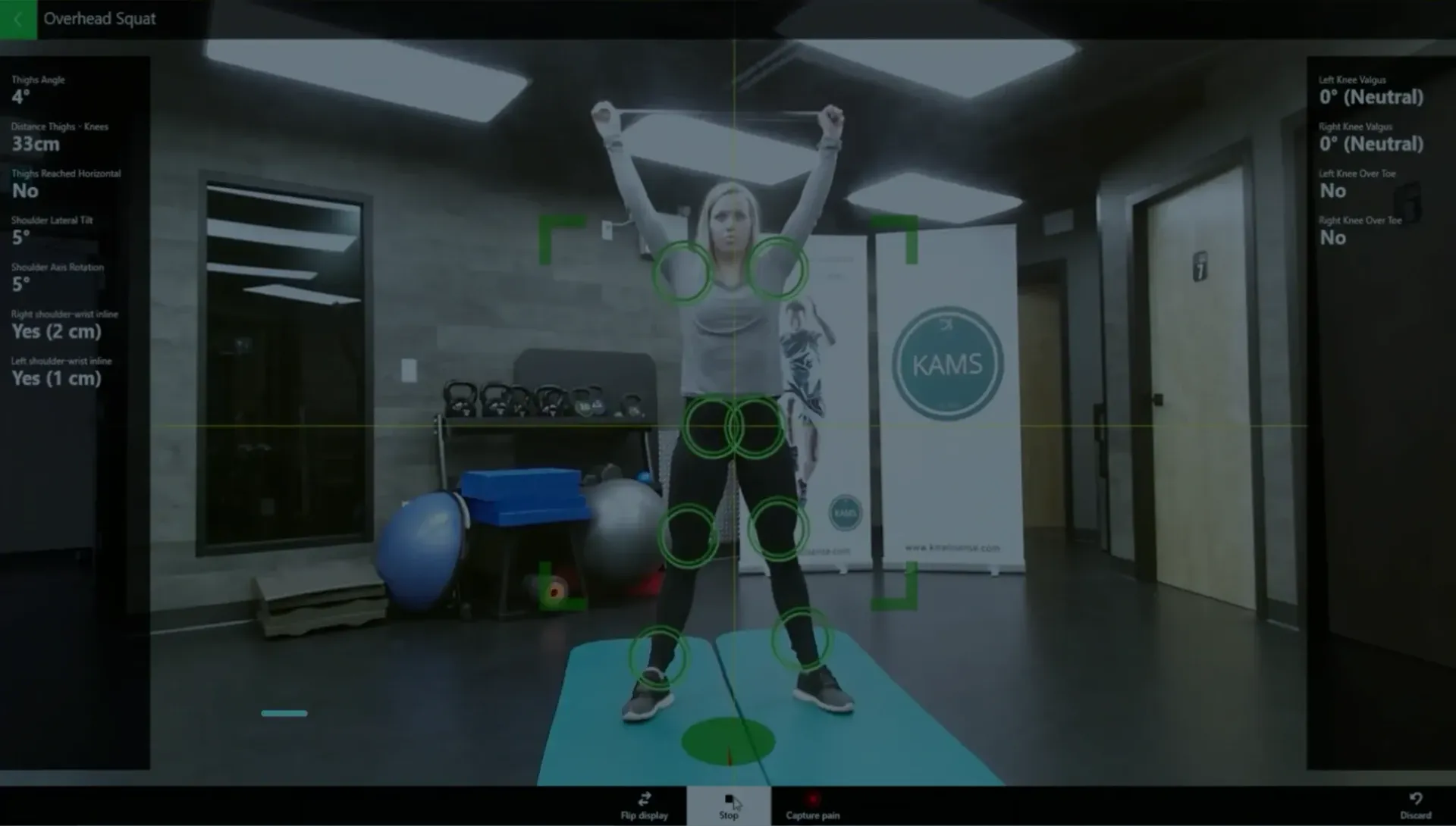 A woman lifting weights while simultaneously undergoing a KinetiSense scan, showcasing Objective Progress Tracking. This data-driven approach enables accurate measurement and tracking of her progress over time, serving as motivation to stay committed to her training goals.