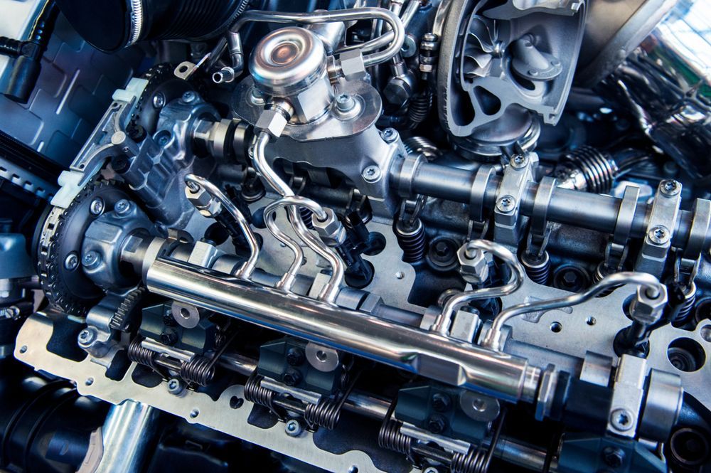 Close-up of a complex car engine with silver fuel lines and various mechanical parts — Resurge Diesel & Fabrication Pty Ltd In Balnagowan, QLD