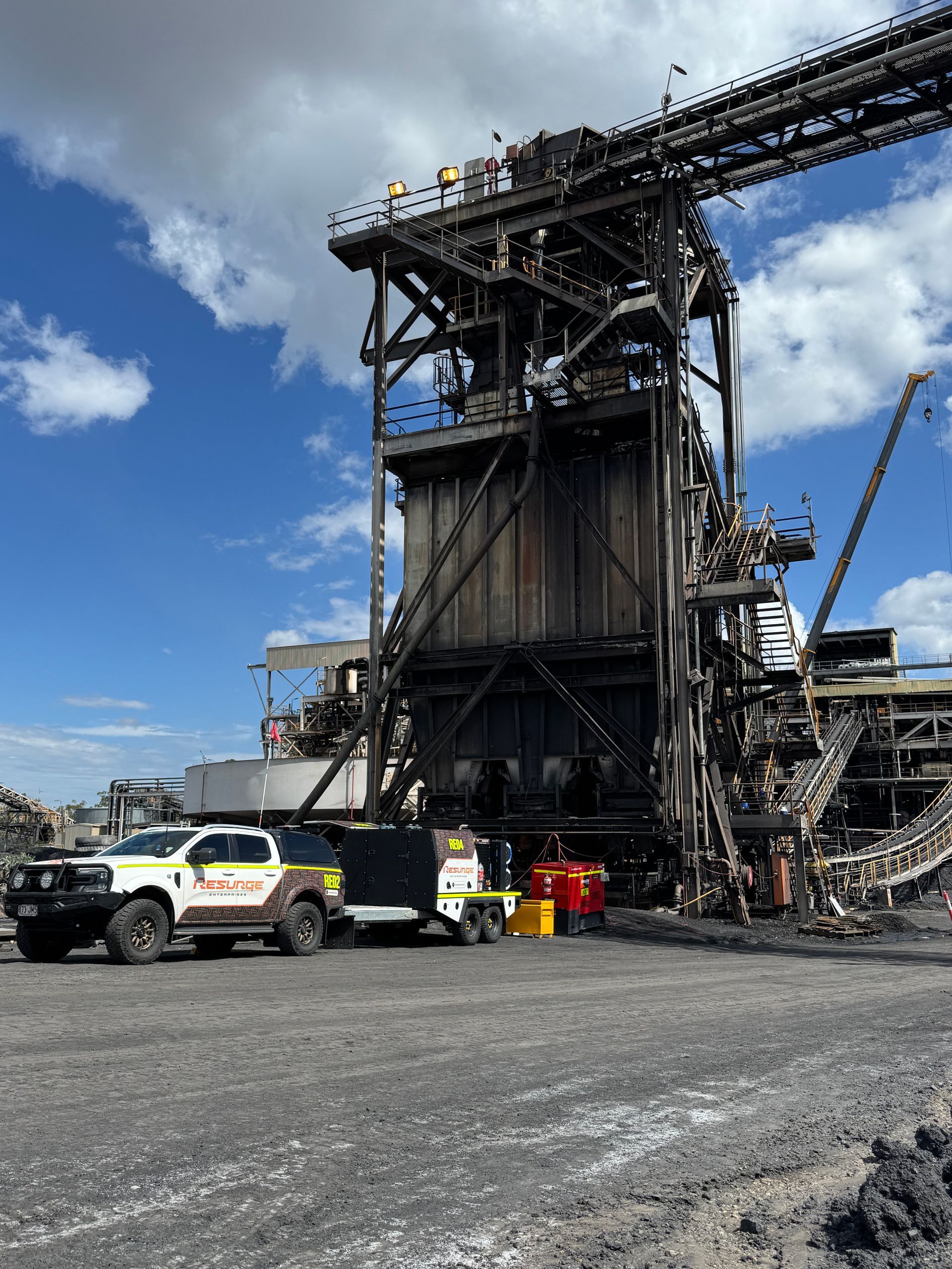 Damaged industrial structure with emergency vehicles and debris under a blue sky — Resurge Diesel & Fabrication Pty Ltd In Balnagowan, QLD