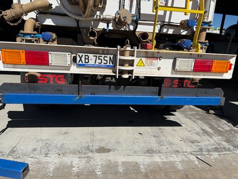 Rear of a truck with license plate XB-75N and blue rear underride guard, parked on pavement — Resurge Diesel & Fabrication Pty Ltd In Balnagowan, QLD