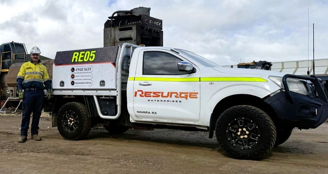 White rescue truck with black accents and off-road tyres parked on dirt near a worker in safety gear — Resurge Diesel & Fabrication Pty Ltd In Balnagowan, QLD