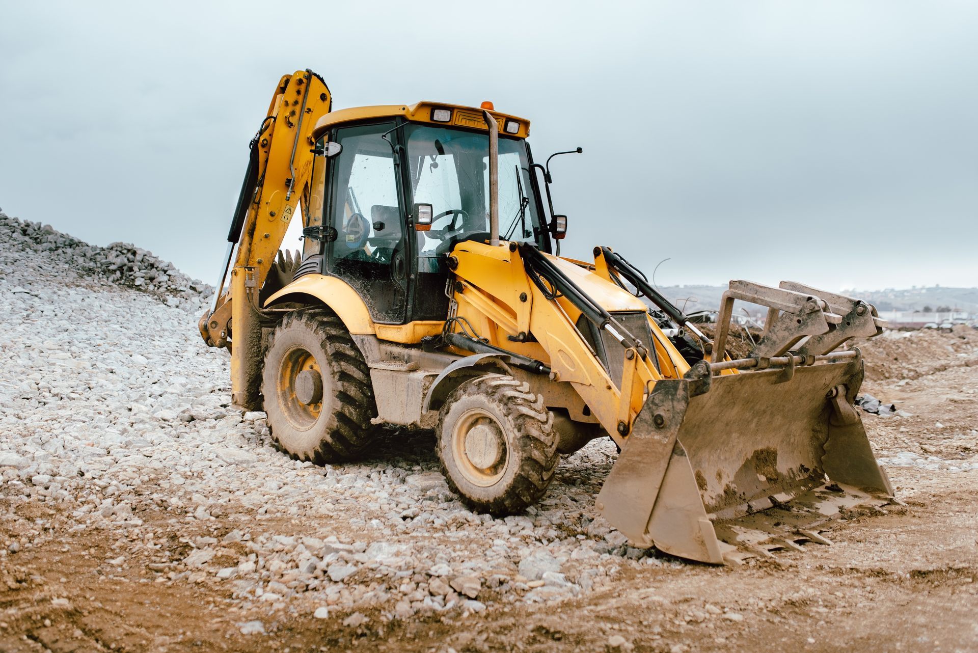 Yellow Backhoe Loader On A Construction Site With Cloudy Sky — Resurge Diesel & Fabrication Pty Ltd In Balnagowan, QLD