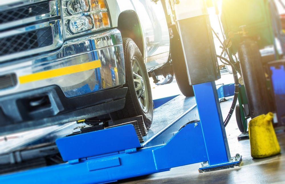 Truck on a Blue Lift in a Garage — Resurge Diesel & Fabrication Pty Ltd In Balnagowan, QLD