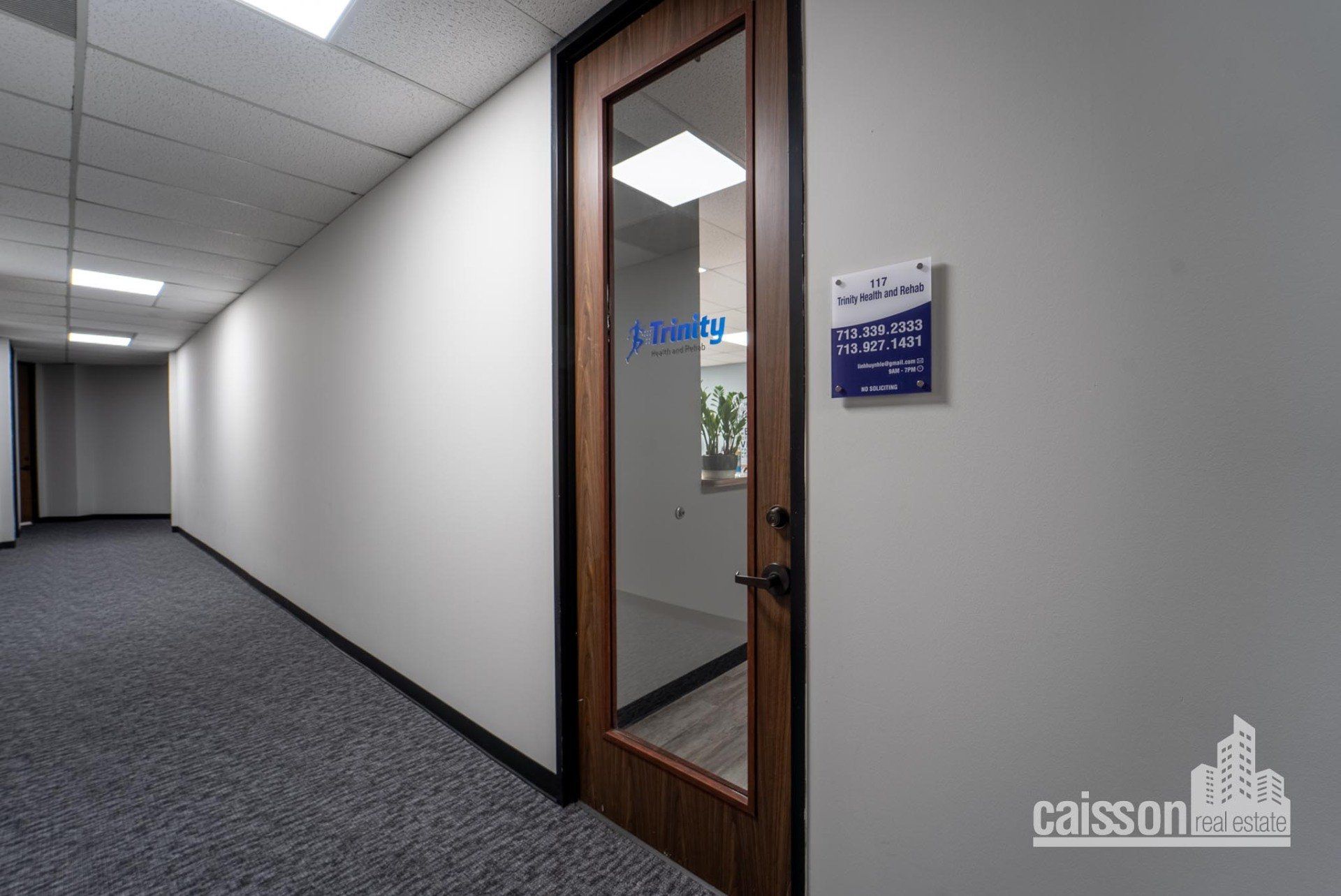 Interior view WestPark hallway with carpet and view of front door of a suite