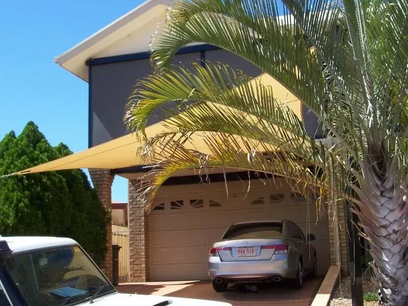 A Car Parked In A Driveway Under A Shade Sail — Shadetech in Alice in Ciccone, NT