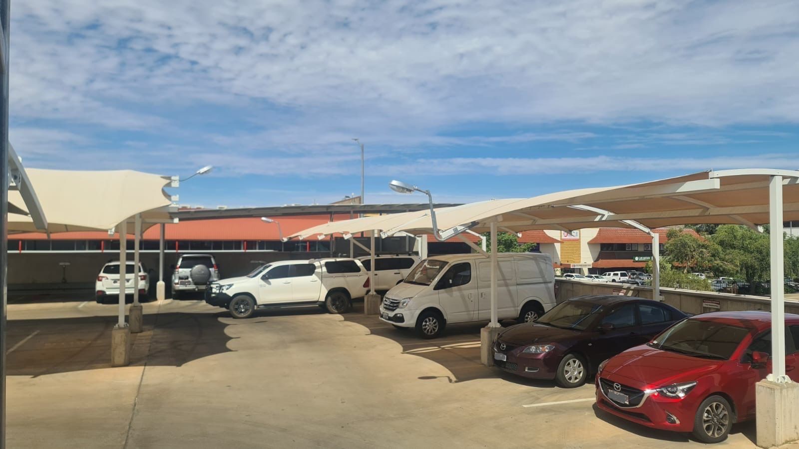A Yellow Shade Sail over a Driveway  — Shadetech in Alice in Ciccone, NT