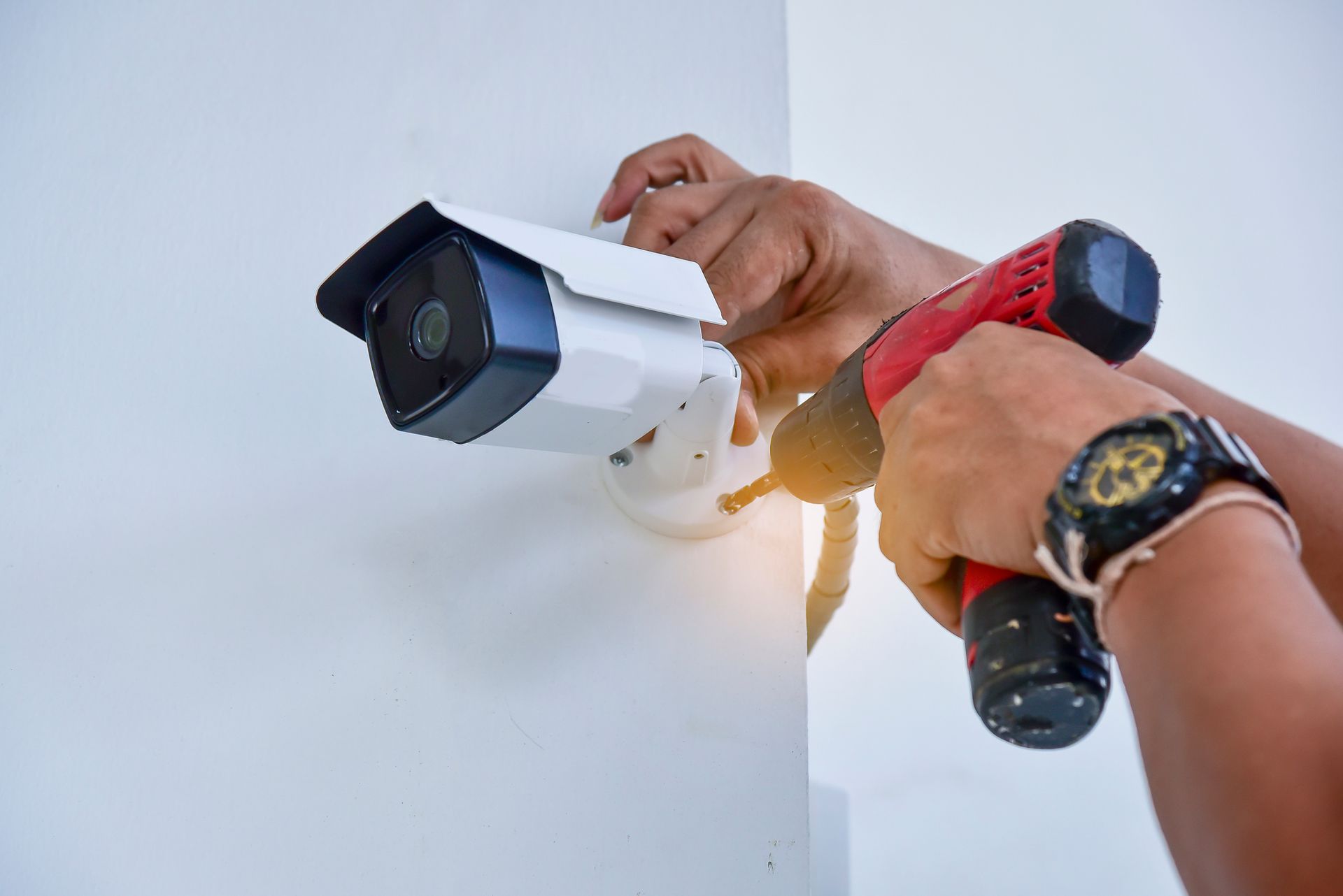 Technician installing a CCTV camera at a commercial property Technician installing a CCTV camera at a commercial property