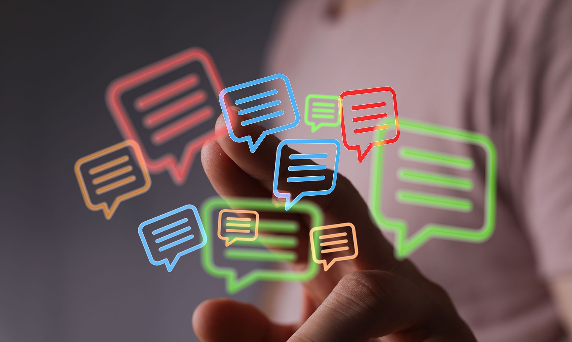 Finger hovering over colorful message bubbles. Concept for digital marketing and instant communication on touch screen interface