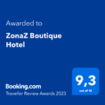 A blue sign that says `` awarded to zonaz boutique hotel '' on it.