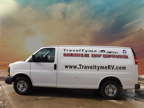 A white van with the website www.traveltymerv.com on the side