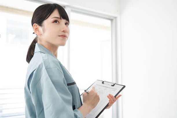 A woman is holding a clipboard and writing on it.