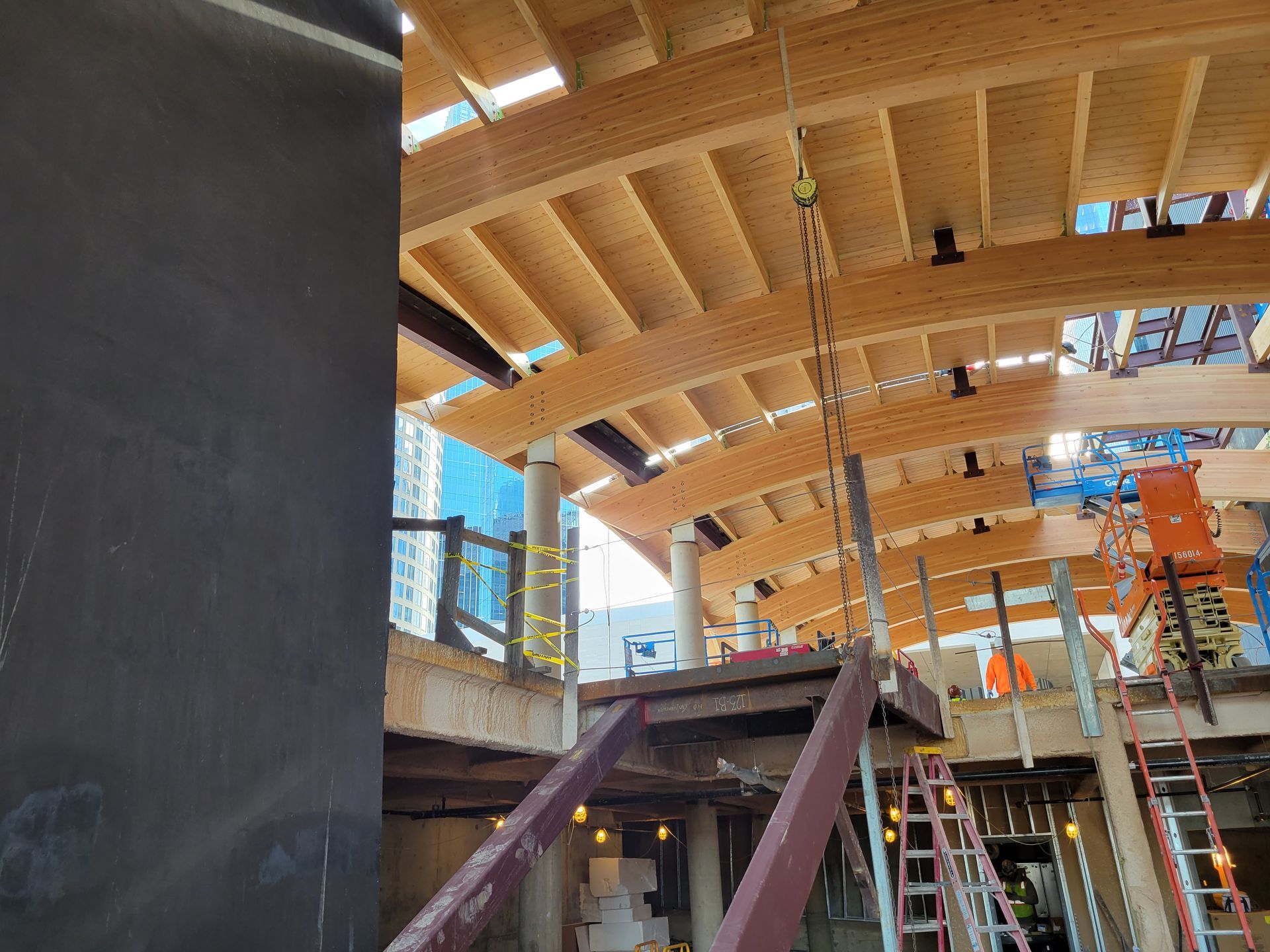 A construction site with a lot of wooden beams and stairs.