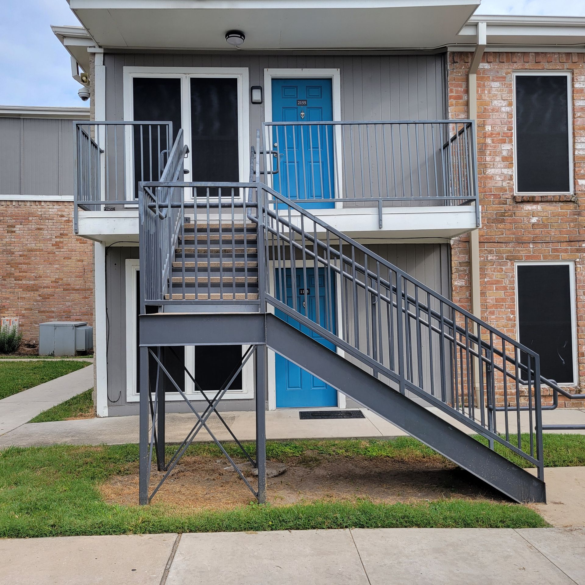 A building with stairs leading up to the second floor