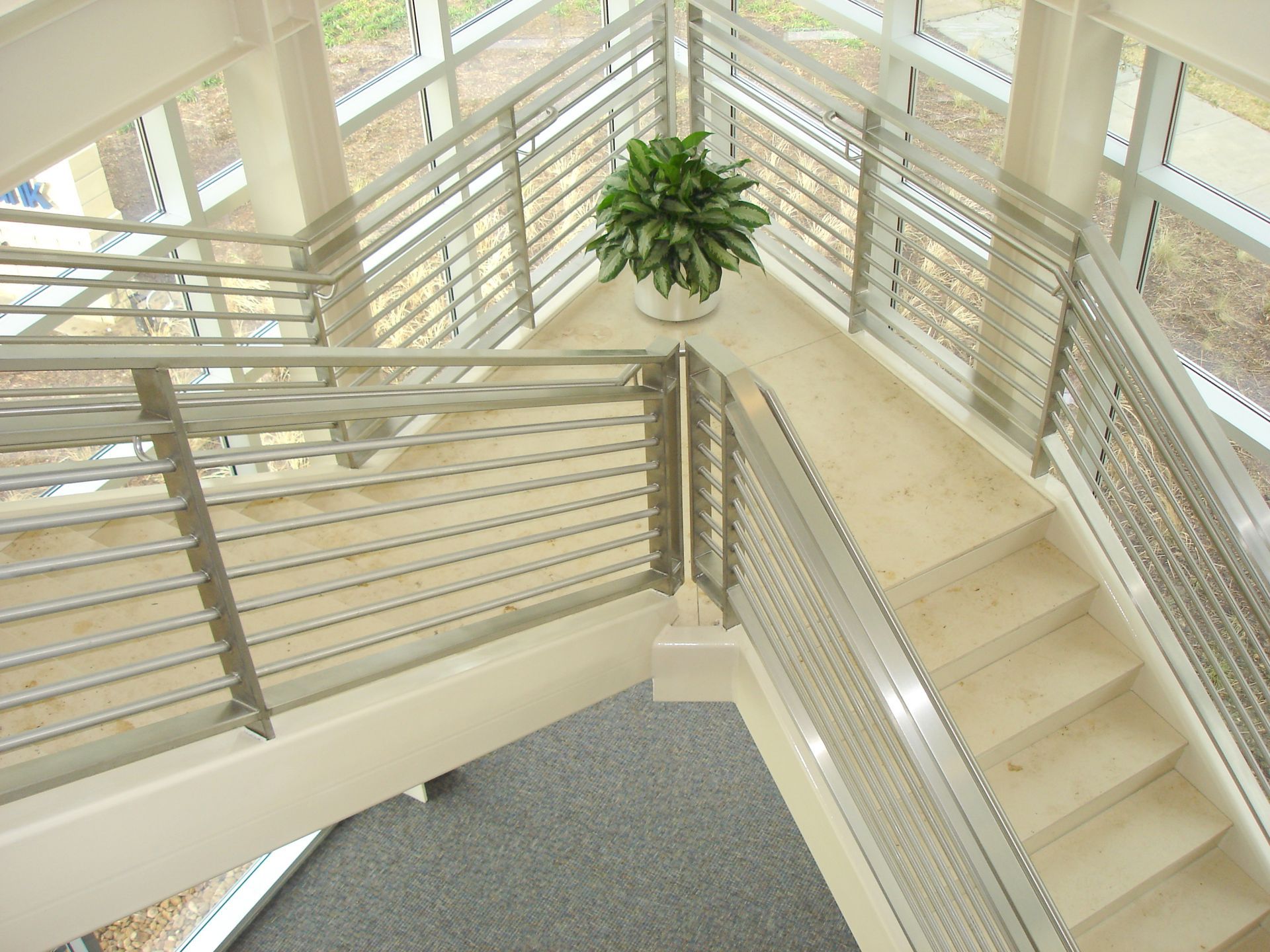 An aerial view of a staircase with a plant in the middle