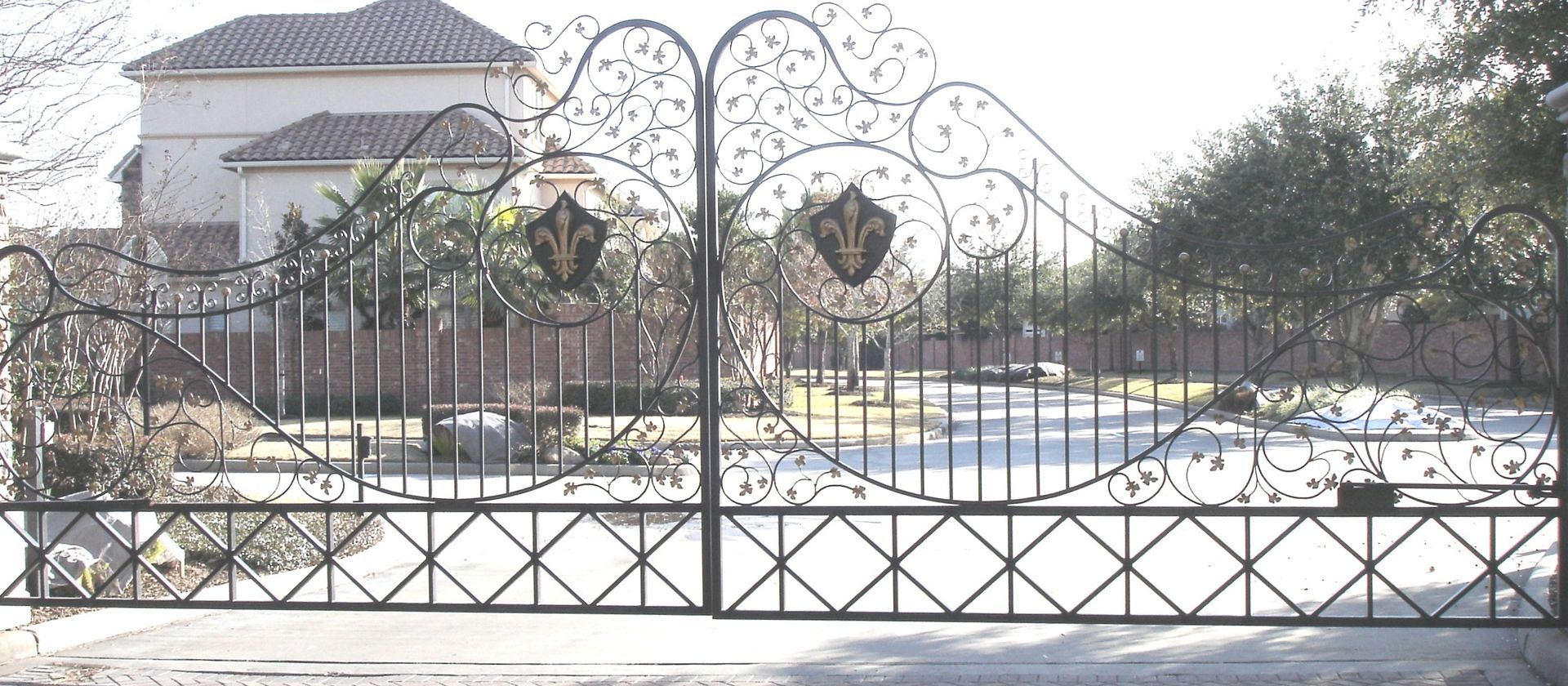 A wrought iron gate in front of a house