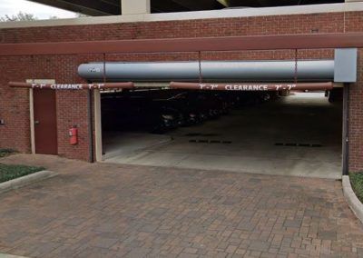 A brick building with a parking garage underneath it.