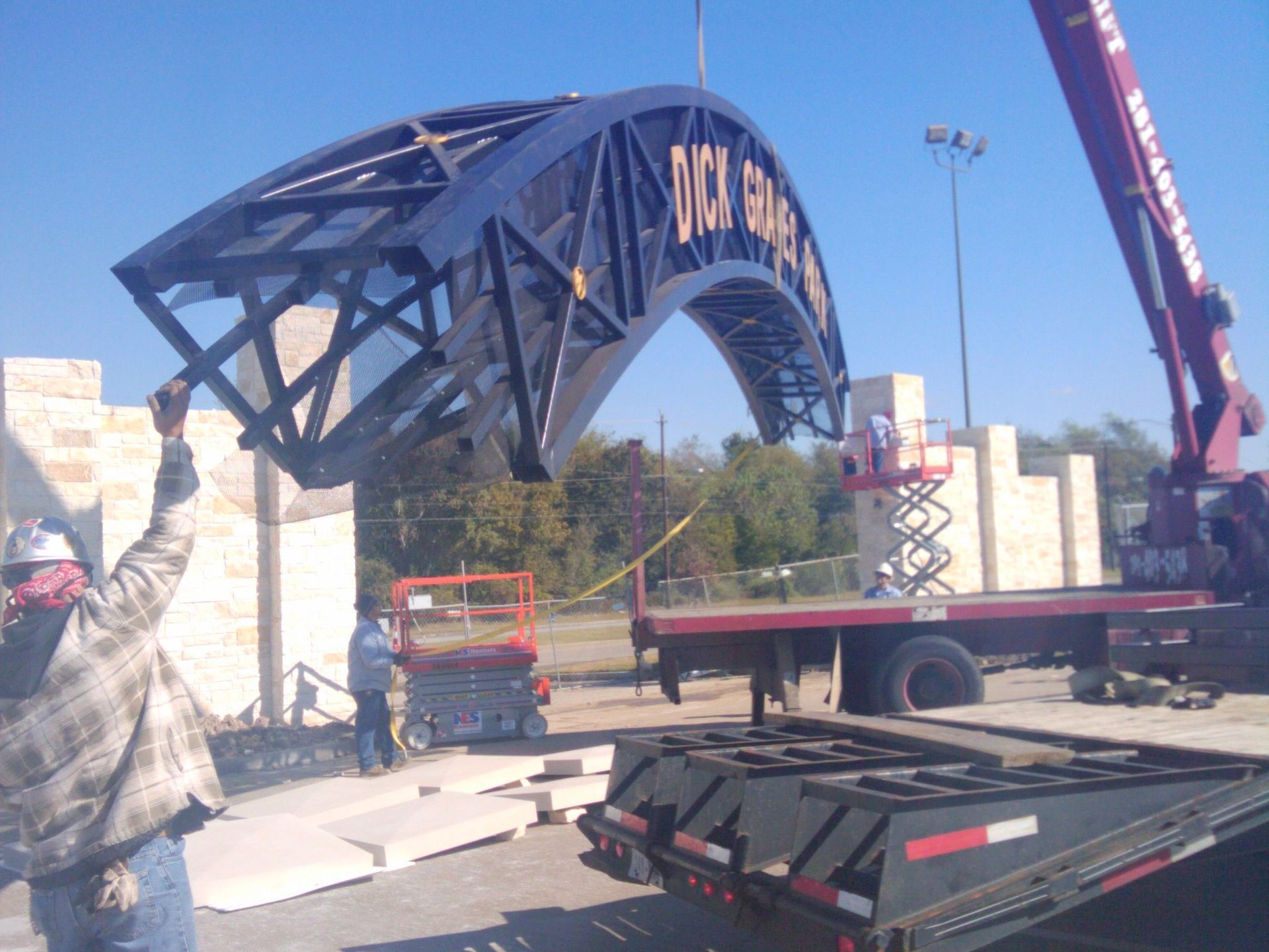 A crane is lifting a metal structure that says duck river