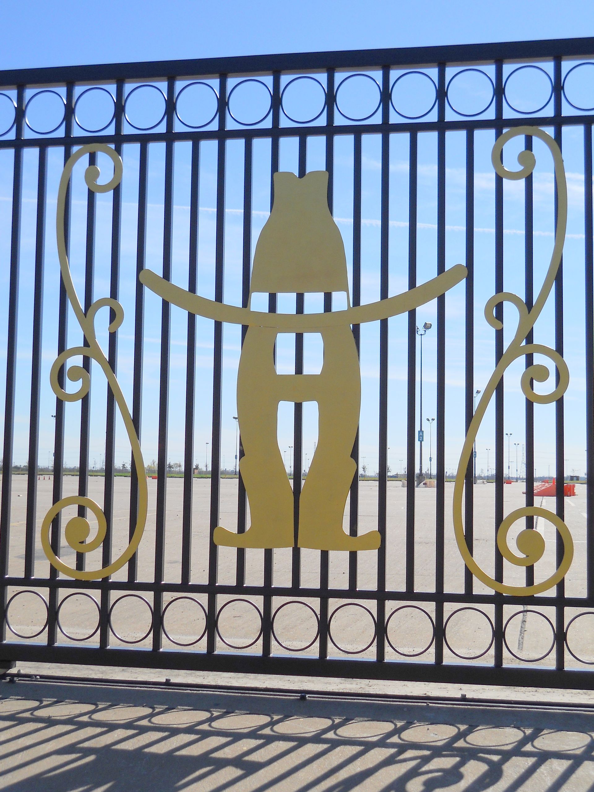 A wrought iron gate with a cowboy on it