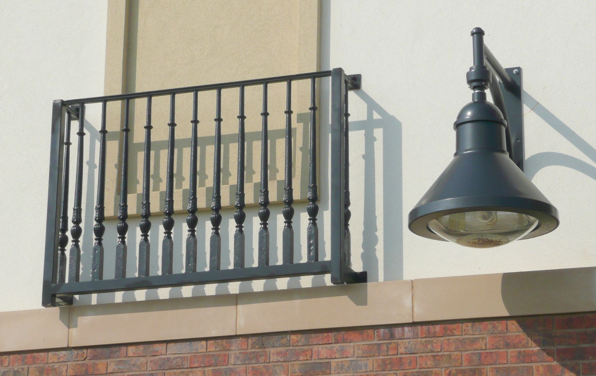 A brick building with a balcony and a street light