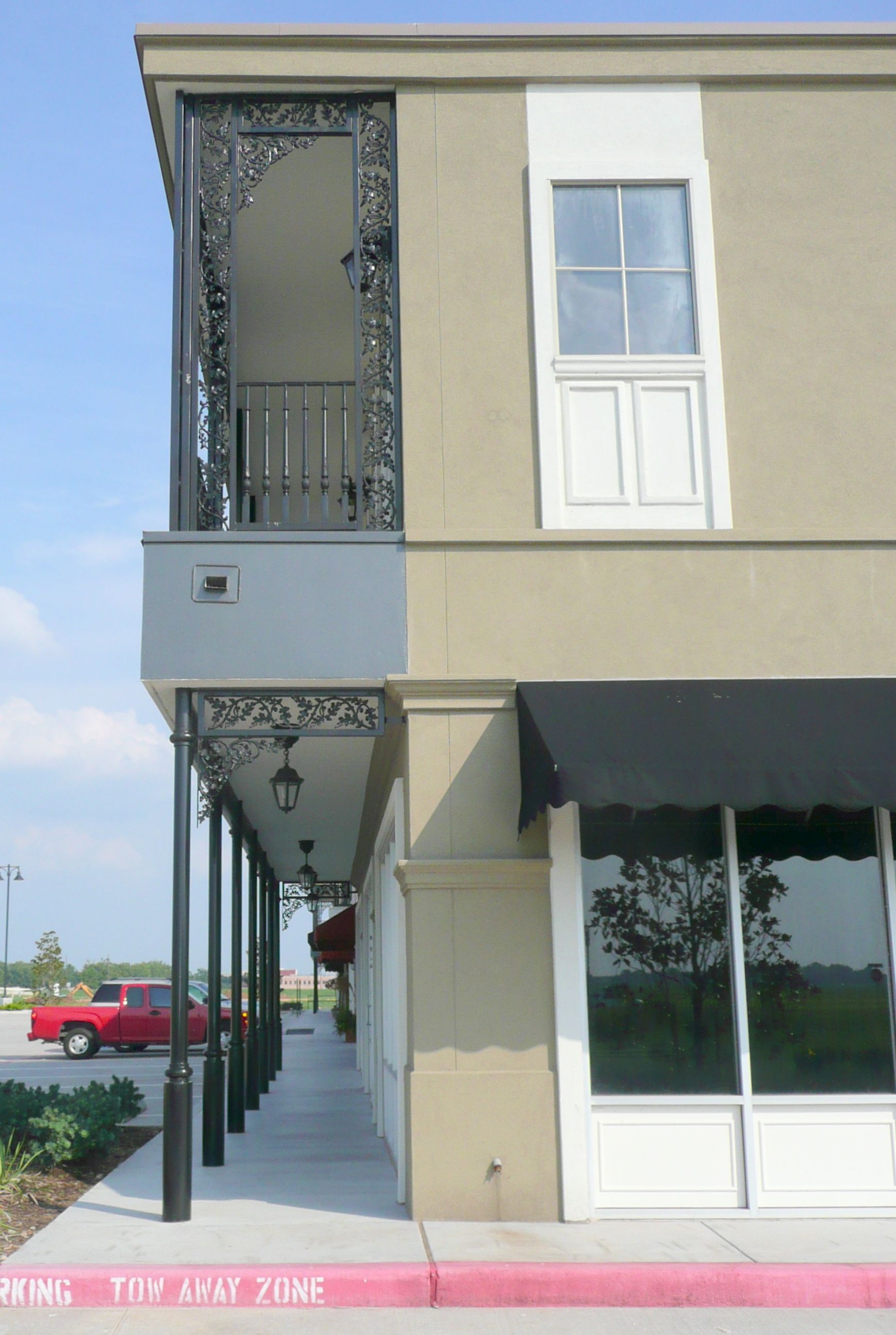 A building with a balcony and a sign that says texas next time