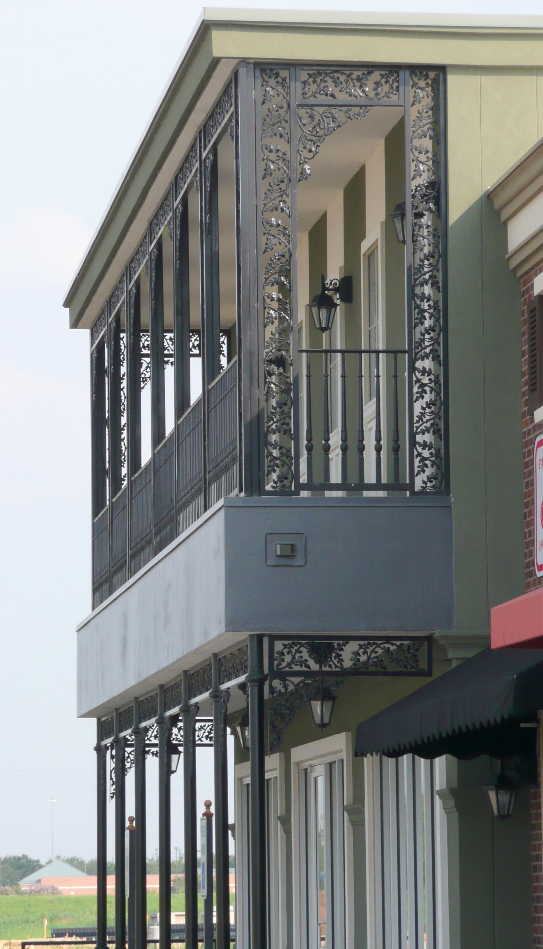 A building with a balcony and a sign that says ' a ' on it