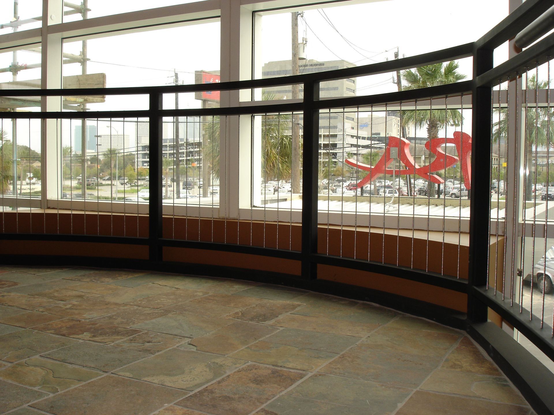 An empty room with a fence and a sign that says ' a & a ' on it