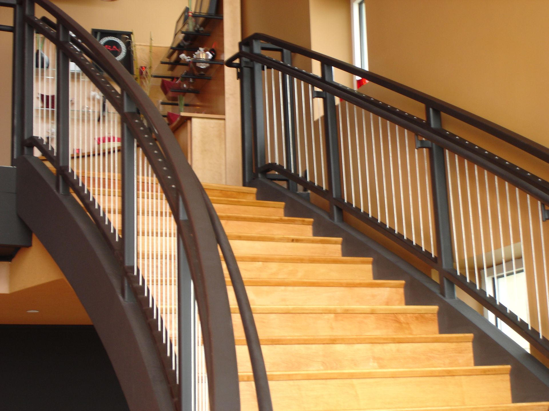 A staircase with a black railing and wooden steps