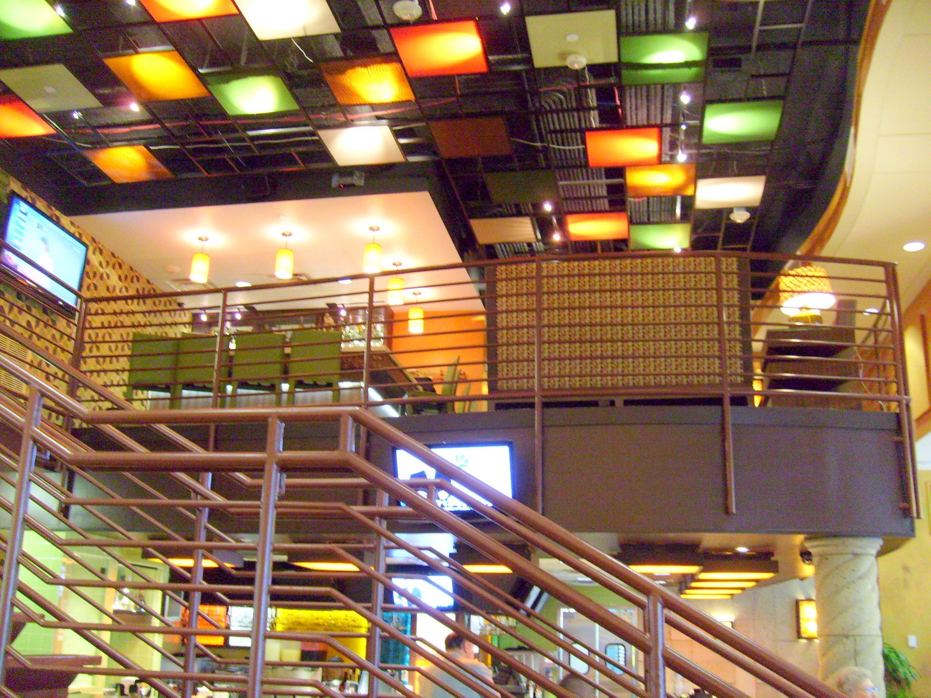A restaurant with stairs leading up to the second floor