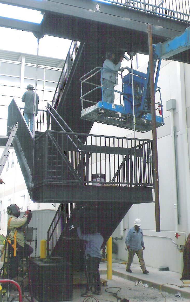 A group of people are working on a set of stairs