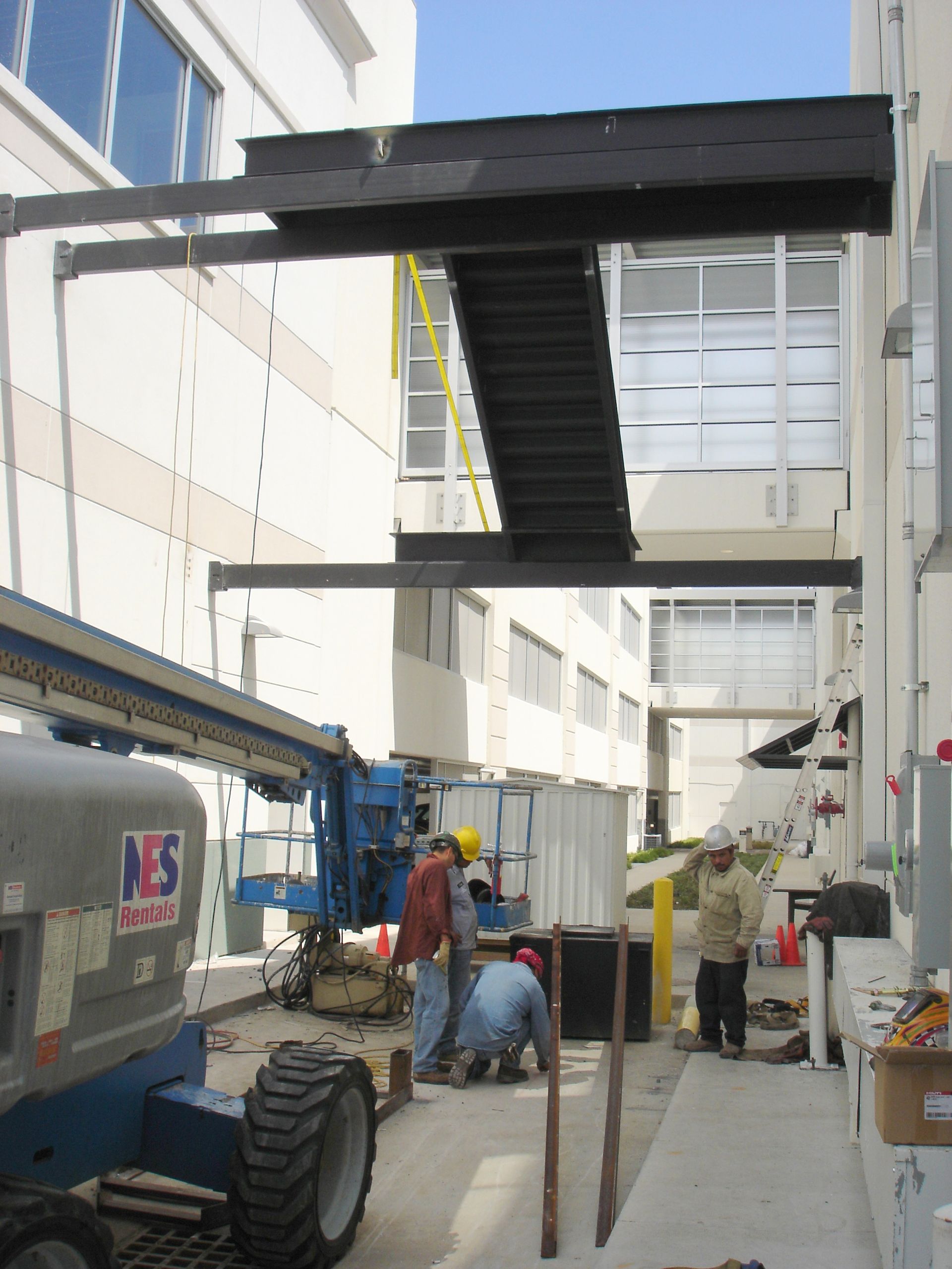 A n.e.s. construction vehicle is parked in front of a building