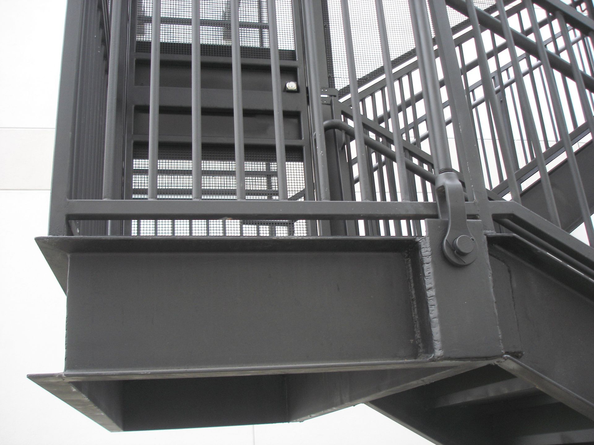 A close up of a metal staircase with a railing