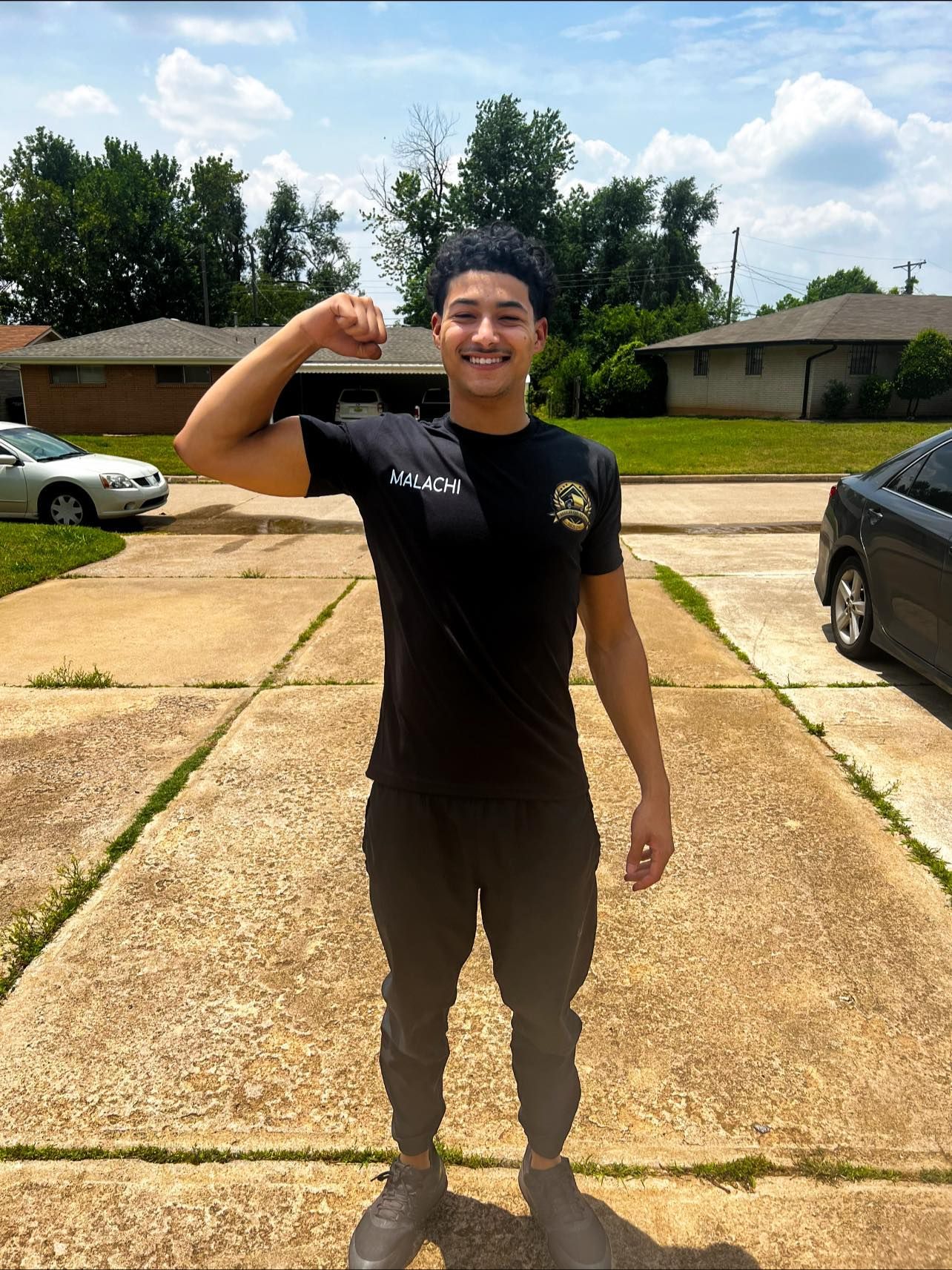 Red carpet runner on a staircase, protected by moving blankets. Beige walls.